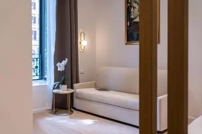 a living room with a couch and a table at Romart Luxury Rooms in Rome