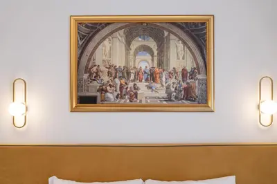 a painting above a bed in a hotel room at Romart Luxury Rooms in Rome