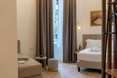 a hotel room with a bed and a window at Romart Luxury Rooms in Rome