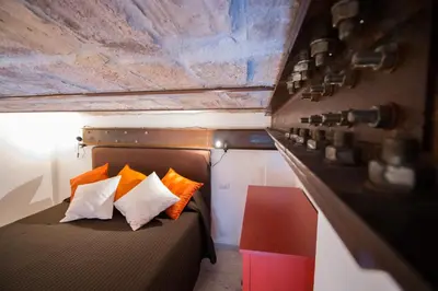 a bedroom with a bed with orange and white pillows at Inner House in Rome