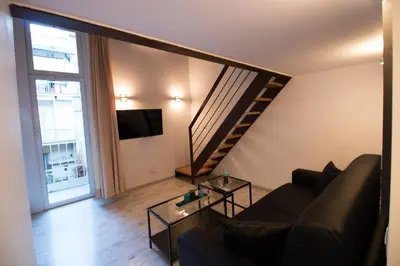 a living room with a couch and a staircase at Inner House in Rome