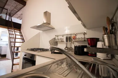 a kitchen with a sink and a stove top oven at Inner House in Rome