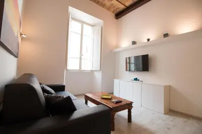 a living room with a couch and a table at Inner House in Rome