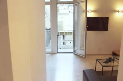 a living room with a couch and a table and a sliding glass door at Inner House in Rome