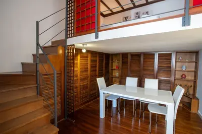 a dining room with a white table and chairs at Pgrhome Campitelli in Rome