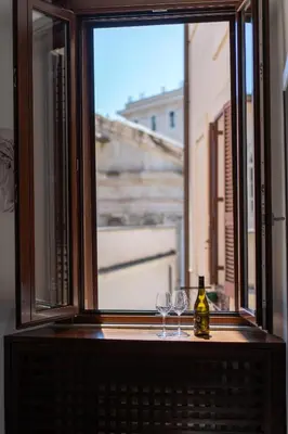 a window with two glasses and a bottle of wine at Pgrhome Campitelli in Rome