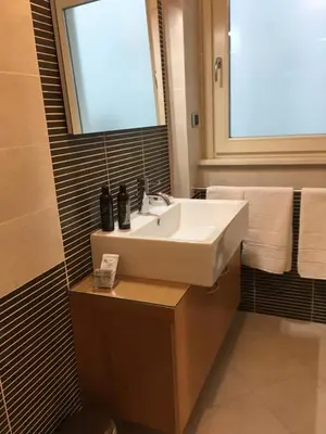 a bathroom with a sink and a window and towels at magic portaportese in Rome