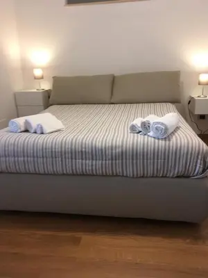 a bedroom with a bed with towels on it at magic portaportese in Rome