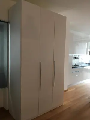 a large white cabinet in a room with a kitchen at magic portaportese in Rome