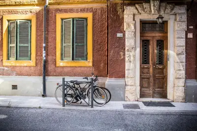 a bike parked on a sidewalk in front of a building at San Pietro Leisure and Luxury in Rome