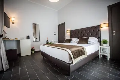 a bedroom with a large bed with a large headboard at San Pietro Leisure and Luxury in Rome