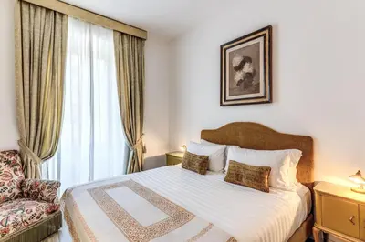 a bedroom with a bed and a chair and a window at BoHo Studio & Terrace in Rome