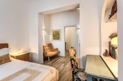 a bedroom with a bed and a desk and a chair at BoHo Studio & Terrace in Rome