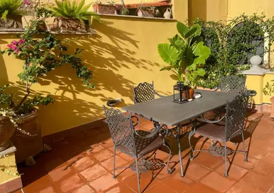 a table and chairs in a patio with potted plants at BoHo Studio & Terrace in Rome