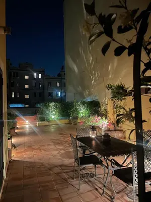 a table and chairs on a patio at night at BoHo Studio & Terrace in Rome