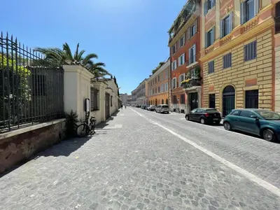 an empty street with cars parked on the side of a building at Foro Romano Apartments C in Rome