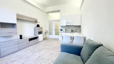 a living room with a couch and a kitchen at Foro Romano Apartments C in Rome