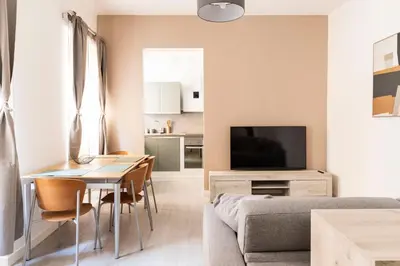 a living room with a couch and a table and a television at Comfort Suite Balduina - Rome in Rome