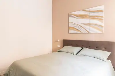 a bedroom with a bed and a painting on the wall at Comfort Suite Balduina - Rome in Rome