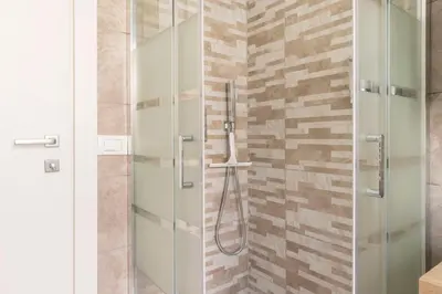 a shower with a glass door in a bathroom at Comfort Suite Balduina - Rome in Rome