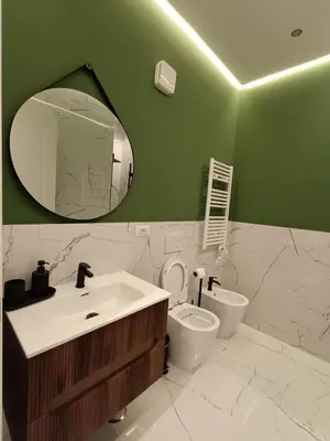 a bathroom with a sink and a toilet and a mirror at Luxury Rome Vatican's Garden in Rome
