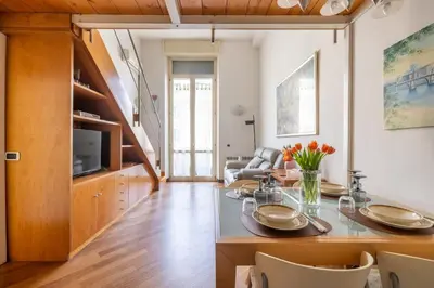 a living room with a dining room table with chairs at Parioli Suite-duplex apartment in Rome