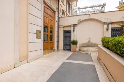 an empty hallway of a building with wooden doors at Parioli Suite-duplex apartment in Rome