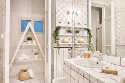 a white bathroom with a sink and a mirror at Gianicolo Maison nel cuore di Roma in Rome