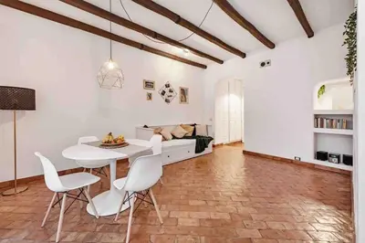 a living room with a table and chairs and a couch at Gianicolo Maison nel cuore di Roma in Rome