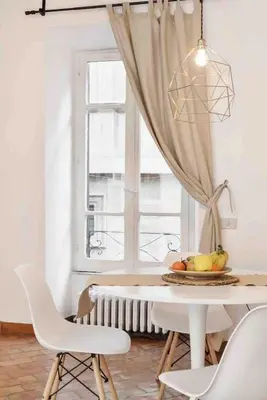 a dining room with a table and chairs and a window at Gianicolo Maison nel cuore di Roma in Rome