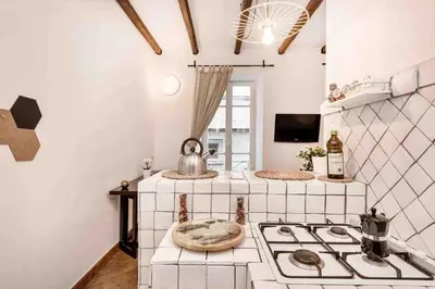 a kitchen with a tea kettle on top of a stove at Gianicolo Maison nel cuore di Roma in Rome