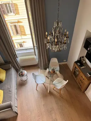 a living room with a chandelier and a table and chairs at Residenza Labicana few steps from Colosseum in Rome