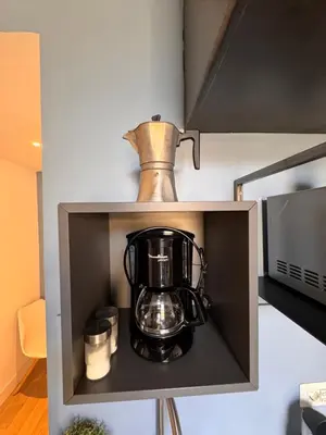 a coffee maker on a shelf in a kitchen at Residenza Labicana few steps from Colosseum in Rome