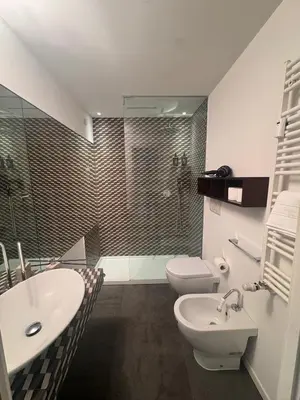 a bathroom with a shower and a toilet and a sink at Residenza Labicana few steps from Colosseum in Rome