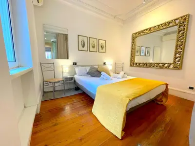 a bedroom with a bed and a mirror on the wall at My Beauty Nest In The Historical Centre in Rome