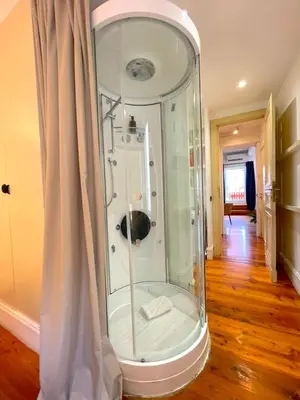 a room with a large glass enclosed room with a curtain at My Beauty Nest In The Historical Centre in Rome