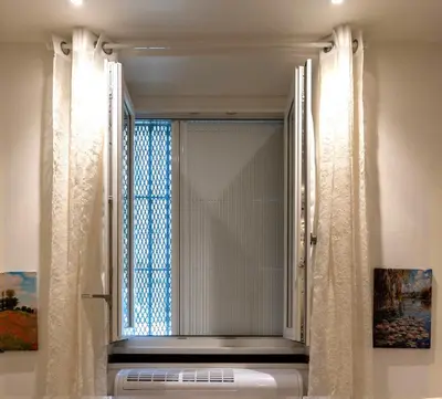 a room with a table with a chair and a mirror at BOHEMIAN PIGNETO RHOME - 2bdr 2bath - Metro Pigneto connecting in 8 minutes to Colosseum - Near Termini Railway station, La Sapienza Uni, Policlinico Umberto I hospital - Family friendly with baby equipment - Vibrant area - Guest care in 4 languages in Rome
