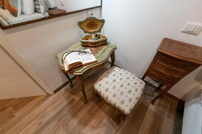 a bedroom with a bed and a desk in a room at BOHEMIAN PIGNETO RHOME - 2bdr 2bath - Metro Pigneto connecting in 8 minutes to Colosseum - Near Termini Railway station, La Sapienza Uni, Policlinico Umberto I hospital - Family friendly with baby equipment - Vibrant area - Guest care in 4 languages in Rome