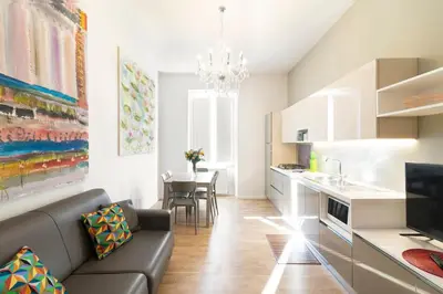 a living room with a couch and a kitchen at Al Vaticano Roma Suite in Rome