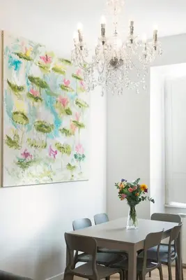 a dining room with a chandelier and a table and chairs at Al Vaticano Roma Suite in Rome