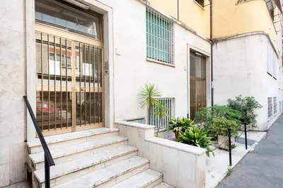 a building with stairs and plants in front of it at Alma Luxury Apartment Elegant 1BR quartiere africano Self Check in Metro B in Rome