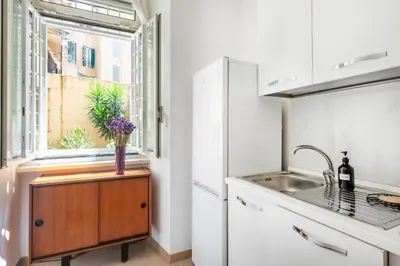 a kitchen with a sink and a window at Alma Luxury Apartment Elegant 1BR quartiere africano Self Check in Metro B in Rome