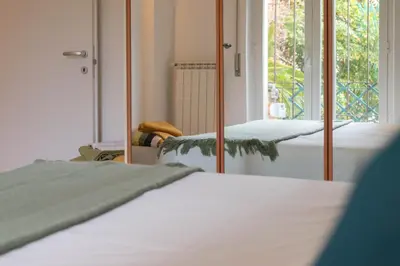 a bedroom with two beds and a mirror at San Pietro Il Campanile in Rome