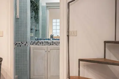 a bathroom with a sink and a shower with blue tiles at San Pietro Il Campanile in Rome