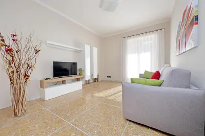 a living room with a couch and a television at Domus 68 - Apartment with terrace in Rome