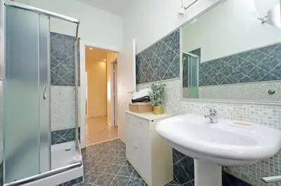 a bathroom with a basket of towels and a sink at Domus 68 - Apartment with terrace in Rome