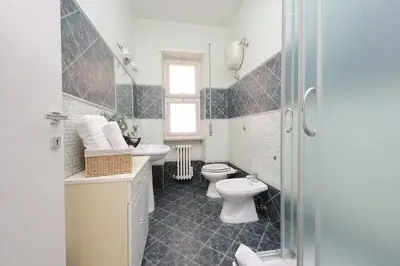a bathroom with a sink and a toilet and a table at Domus 68 - Apartment with terrace in Rome
