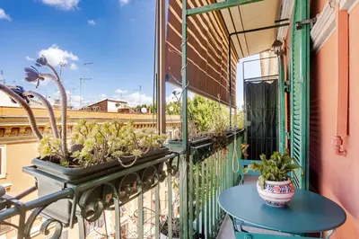 a balcony with a table and potted plants on it at Urbanflat Colosseum in Rome