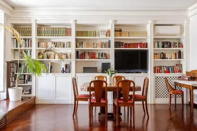 a dining room with a table and a tv at Urbanflat Colosseum in Rome