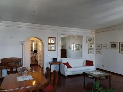 a living room with a white couch and a table at Urbanflat Colosseum in Rome